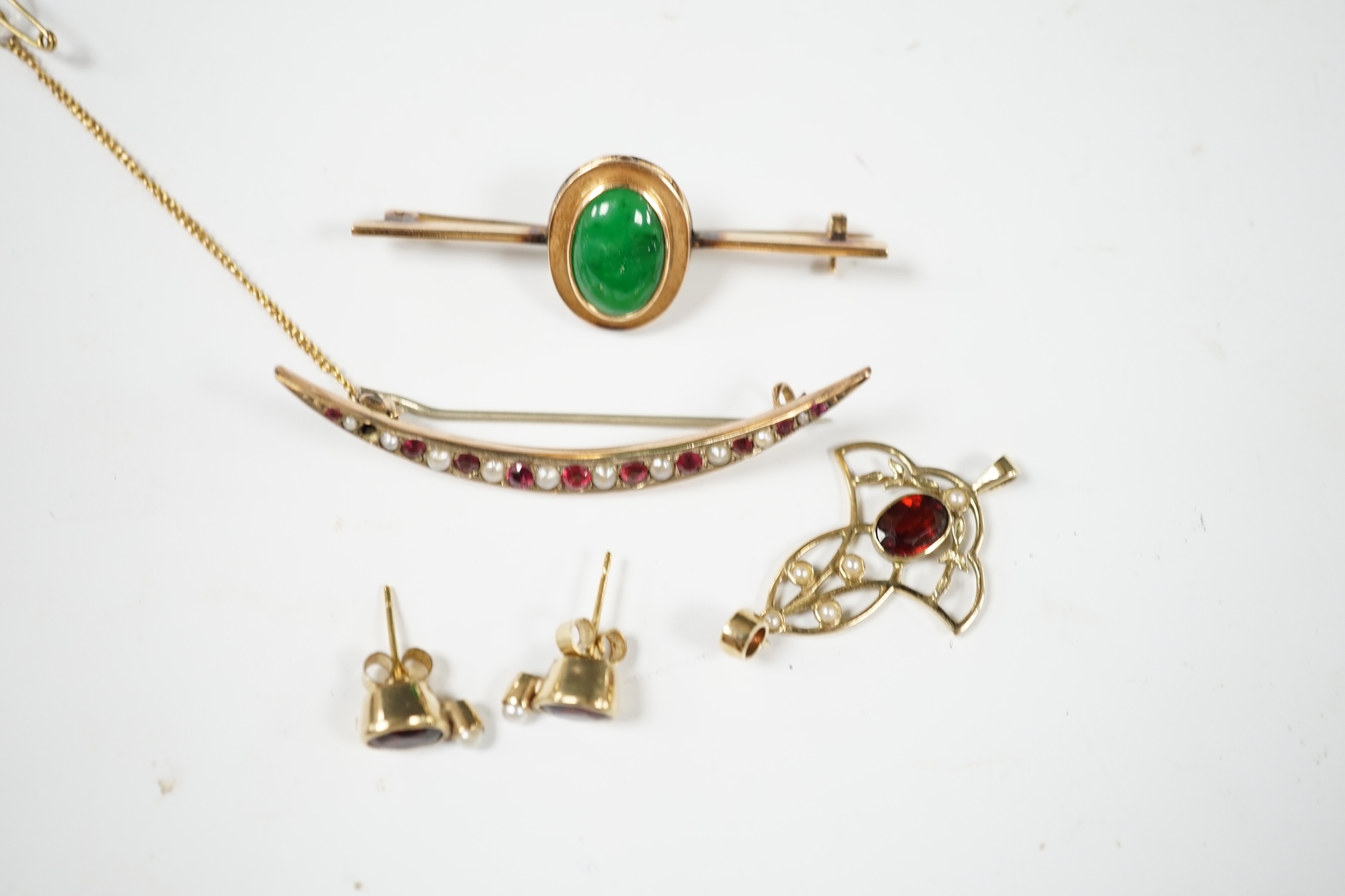 Sundry jewellery including a 9ct and gem set crescent brooch, 51mm, a 9ct, garnet and seed pearl set pendant, a 14ct and jade set bar brooch and a pair of gem set ear studs. Condition - fair to good